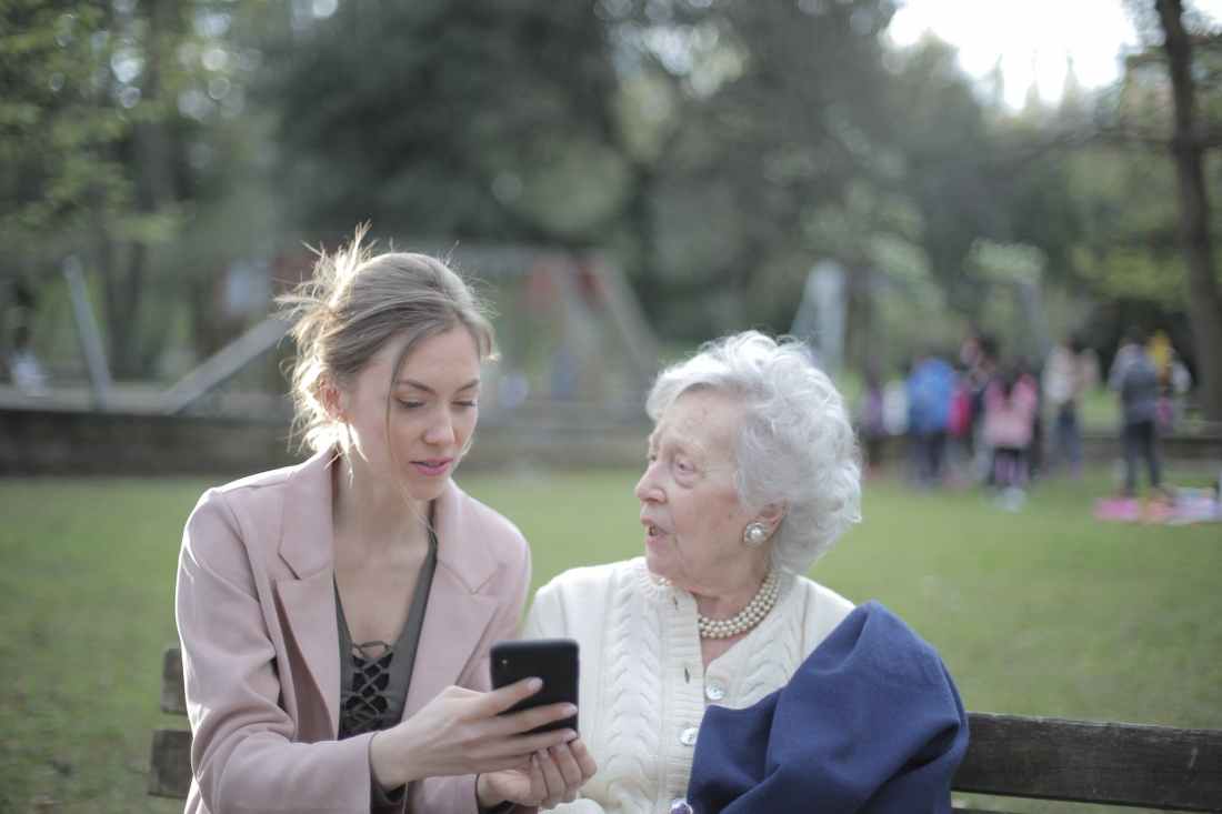 An elderly woman struggling with her phone